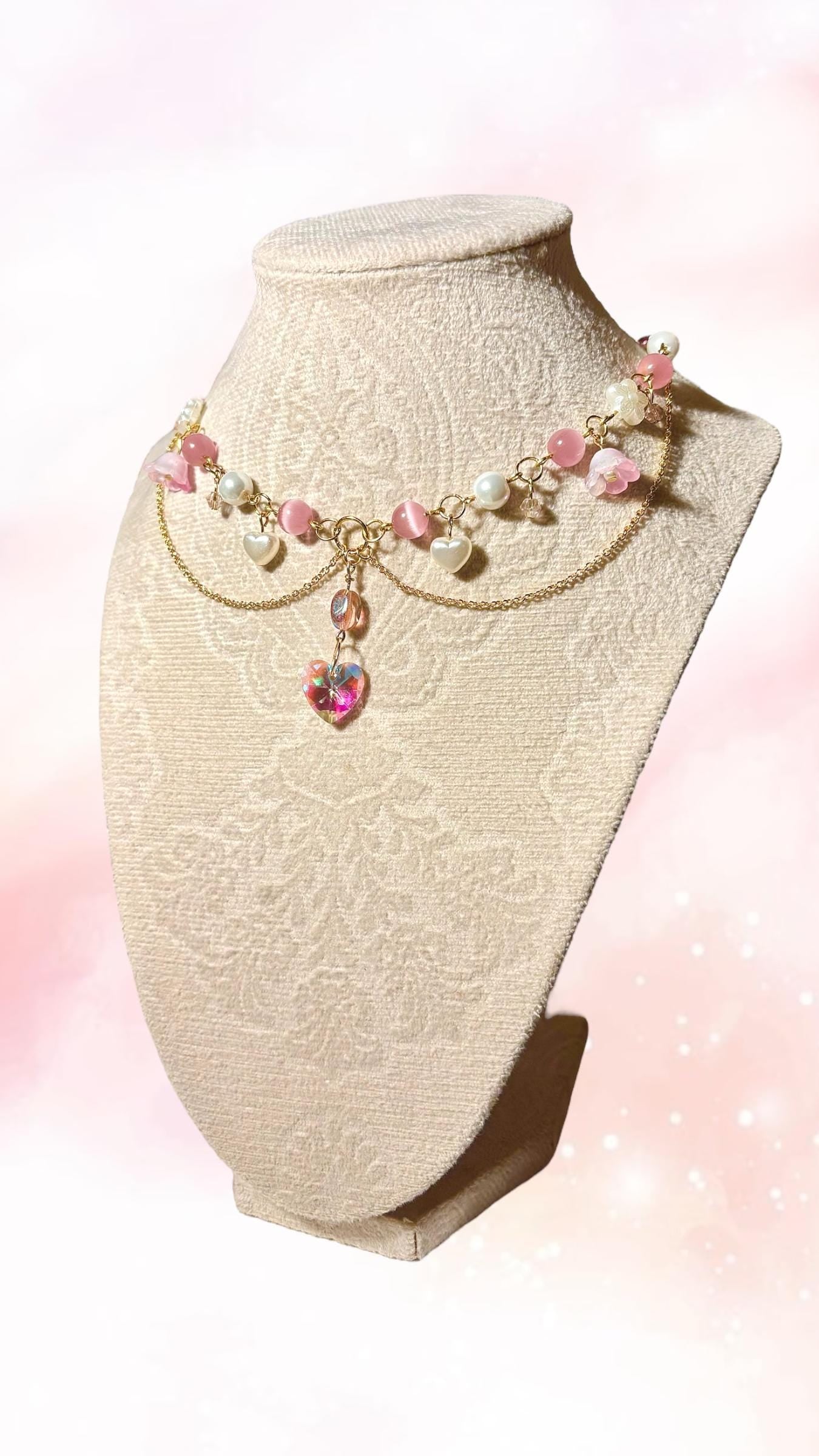 Side view of fairycore-inspired choker necklace showcasing delicate gold-plated chain, pink beads, and floral accents for a whimsical aesthetic.
